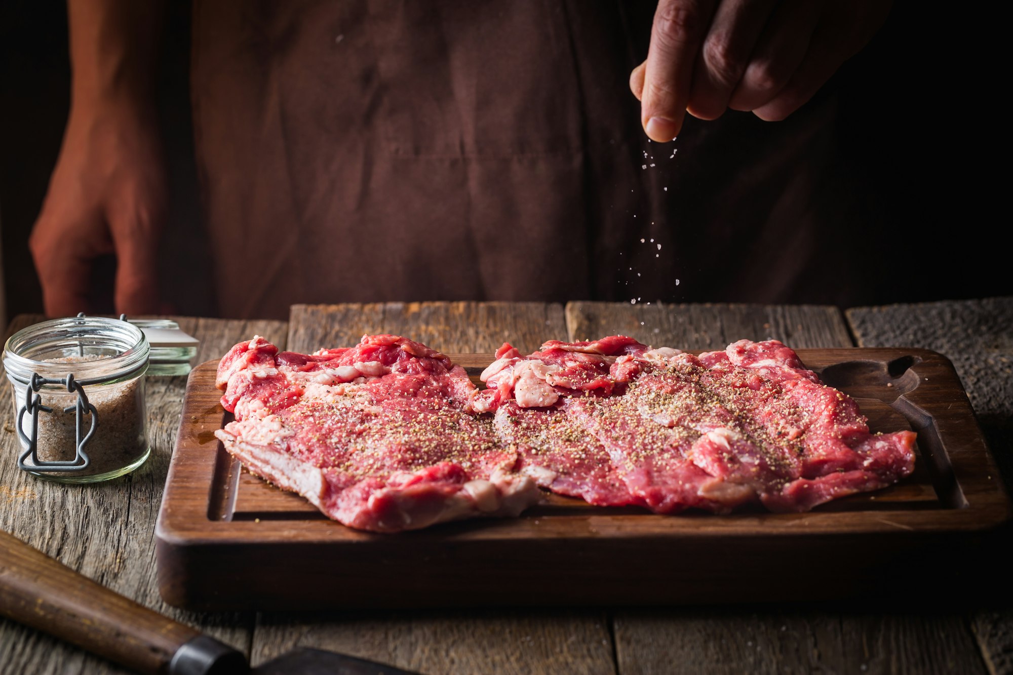 Man cooking meat steaks